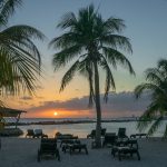 Chairs on beach at sunset