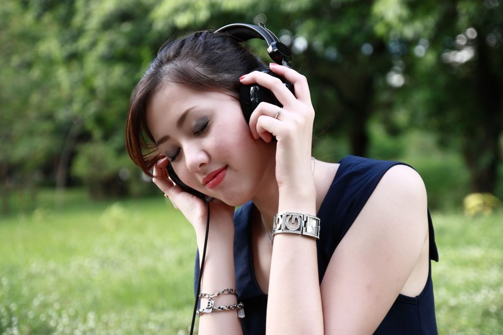 Woman in park with headphones